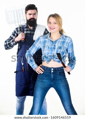 Picnic barbecue. food cooking. Family weekend. Couple in love hold kitchen utensils. Man bearded hipster and girl. Preparation and culinary. Tools for roasting meat. Tasty food and good company.