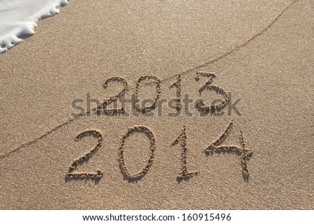 New Year 2014 season is coming concept - inscription 2013 and 2014 on a beach sand Royalty-Free Stock Photo #160915496