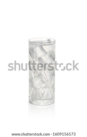 Isolated Gin Fizz cocktail with ice cubes. with reflection