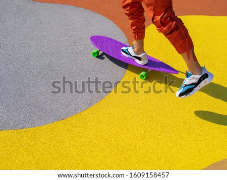 Portrait of a man riding a longboard on the cityscape background. Longboarding in the city. Extreme sport, leisure activity, hobby and motion concept.