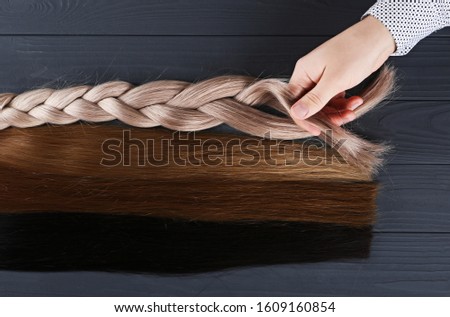 Different types of hair.Blond,red and brown-haired sections.Hair extensions concept.