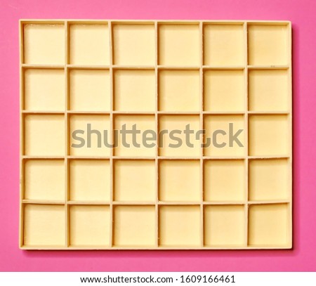 Empty wooden shelves on a pink background