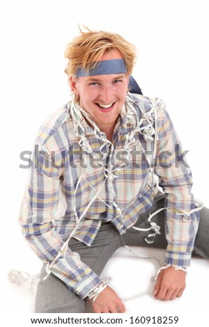 Young attractive party guy with a tie around his head, wearing a shirt and grey pants. White background.