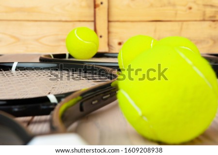 Tennis equipment on wooden surface close up
