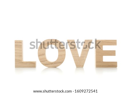 Love made of wooden letters isolated on white background