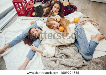 Beautiful mother with children. Family at home. People in a Christmas decorations.