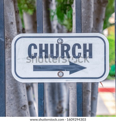 Square frame Church sign pointing to the right on a sunny day