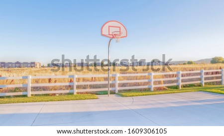 Panorama Empty all weather exterior basketball court on a sunny day