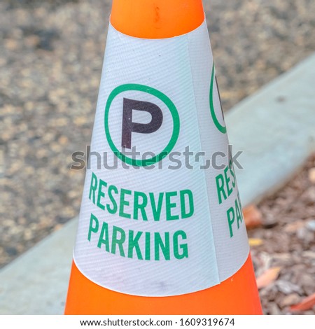 Square frame Traffic cone with Reserved Parking sign close up