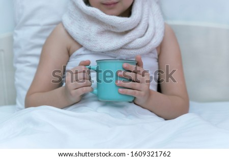 Ill girl child with cup of hot tea stock photo Child, Girls, Winter, Scarf, People