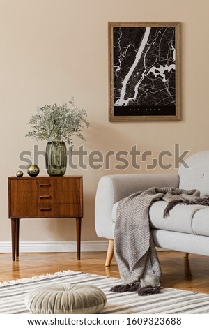 Design scandinavian home interior of living room with mock up poster map, stylish wooden commode, sofa, flowers in vase and elegant personal accessories. Modern home staging. Template Beige concept.
