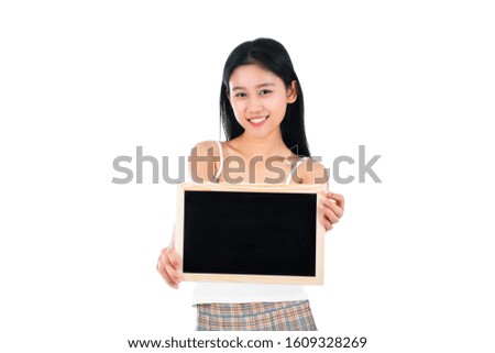 Portrait of attractive asian young woman with beauty skin and face holding blank blackboard.