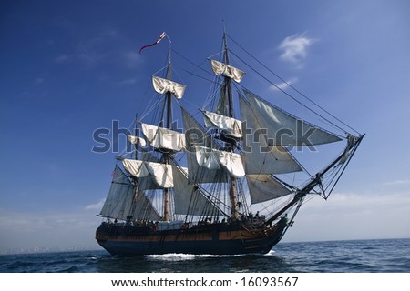 Tall Ship under sail with the shore in the background