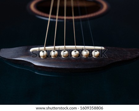close up look to the saddle of a a guitar, isolated, musical concept