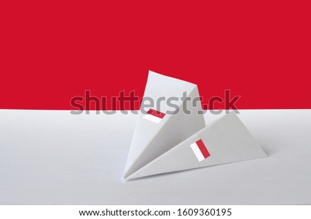 Monaco flag depicted on paper origami airplane. Handmade arts concept