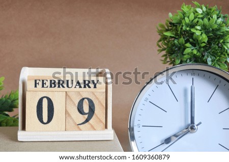 February 9, Cover design with silver - white clock in natural concept.