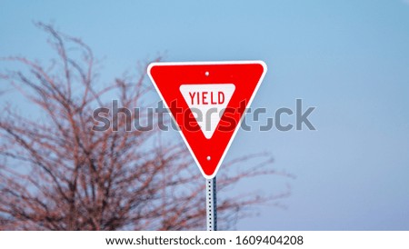 Panorama frame Red traffic Yield sign alongside a road