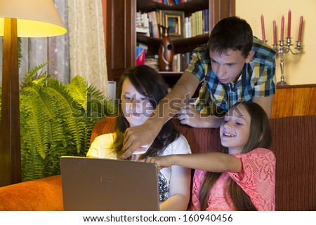 home still life, children watch the laptop in the living room at evening