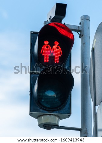 Red traffic light for pedestrians in Vienna, pair of people