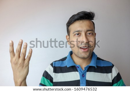 a young indian man confident and smiling indicating four symbol isolated in white background with copy space for text.