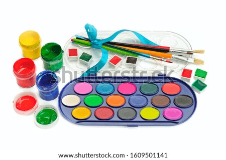 Watercolor paints, gouaches and brushes isolated on white background.