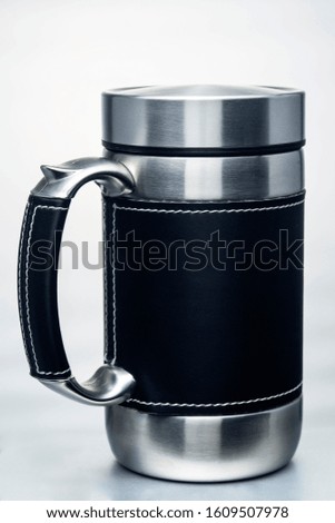 thermos mug with leather trim on white background