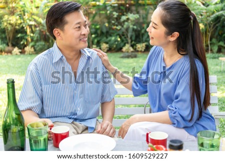 Senior Asian couple counselling , reassuring and discussing at park.