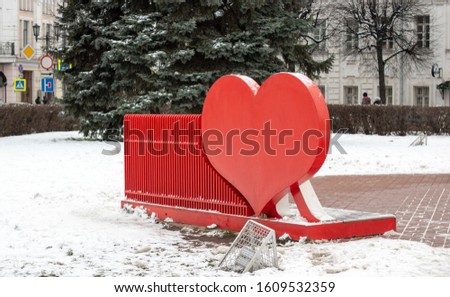red hearts on the back of a bench with forged elements in the Park