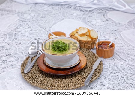 Green broth with cabbage served with toast, grated cheese and pepper.