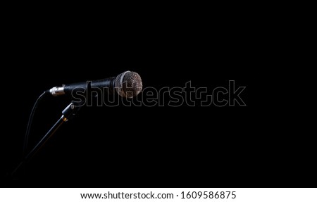 Rusty vintage microphone on black background