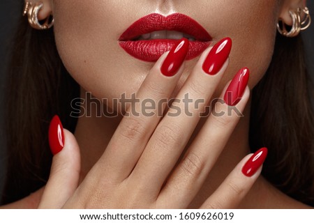 Beautiful girl with a classic make up and multi-colored nails. Manicure design. Beauty face. Photo taken in the studio Royalty-Free Stock Photo #1609626019