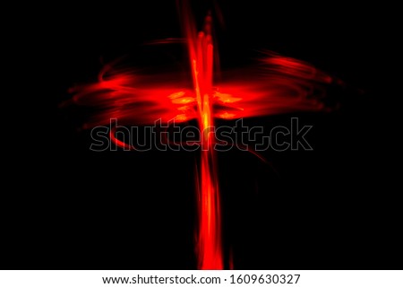 Red colored crucifix like light painting abstract background on a black background.