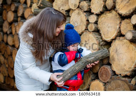 series. Mom and son in the country gather wood