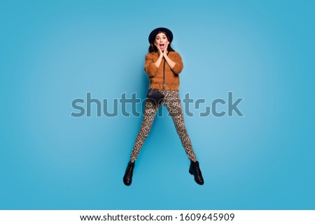 Full size photo of excited funky crazy have fun fall spring holidays look good see black friday bargains jump scream wear stylish clothing isolated over blue color background