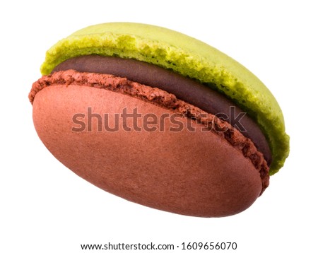 Macro photo of french caramel and pistachio macaroon or macaron isolated on white background, clipping path.