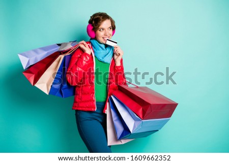 Positive funky girl hipster addicted center client hold bags teeth debite card look copyspace dream green jumper red season wear blue pants trousers isolated turquoise color background