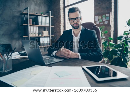 Photo of handsome business guy focused attentively listening vacancy candidate asking interview questions wear specs black blazer shirt suit sitting chair office indoors