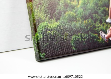 Canvas print, closeup. Stretched photo with gallery wrap method of canvas stretching on stretcher bar. Edge and corner of photography, side view