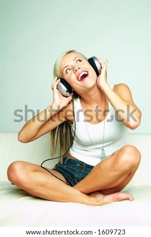 Young beautiful happy women listening music in headphones Royalty-Free Stock Photo #1609723