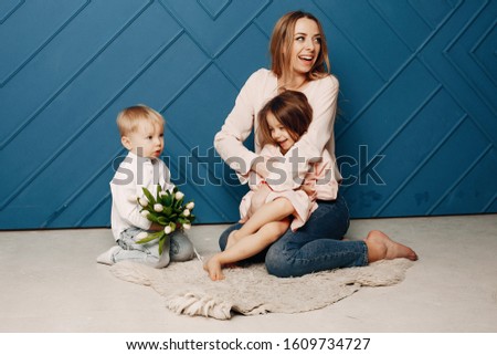 Children give mother flowers. Family at home. Mothers day