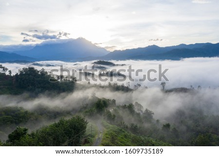 Aerial image of beautiful nature landscape scene of tropical rainforest and clouds with Mount Kinabalu in Sabah, Borneo