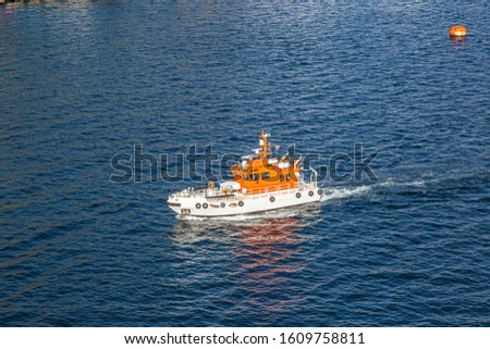 Picture of pilot cutter taken from a cruise ship during daytime