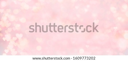 Abstract texture of bokeh lights. Valentine's Day Background. Sparkling lights background. Abstract Valentine Background with Glowing Hearts. Love concept. Wide angle format banner.