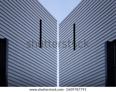 Collage photo of corrugated metal panels resembling modern industrial architecture building exterior. Abstract material background on the subject of construction industry or technology.