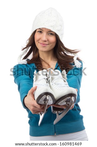 Young woman showing ice skates for winter ice skating sport activity in white hat smiling isolated on a white background