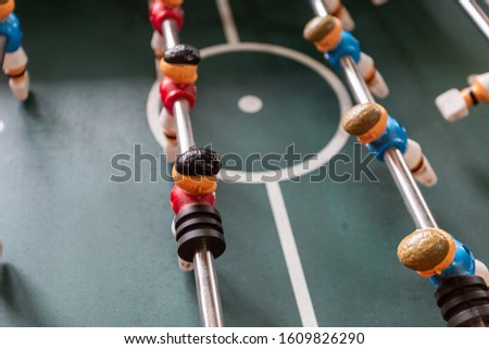 Close-up of colored wooden figures of table football. Foosball game close up