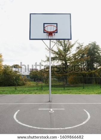 Basketball hoop and a cage with poor asphalt, sports background