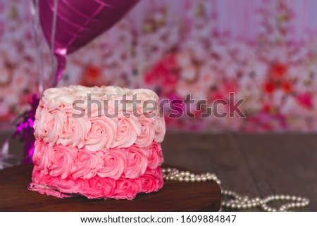Cream rose Cake smash cake on a wooden board with pearls and beads 