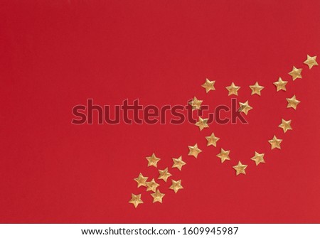 Valentine's Day red background with heart and arrow made of small gold stars. Valentine greeting or invitation card. Love, happiness concept. Flat lay, top view style with copy space for you text.