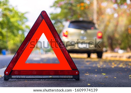 Red triangle, red emergency stop sign, red emergency symbol and  car stop and park on road.